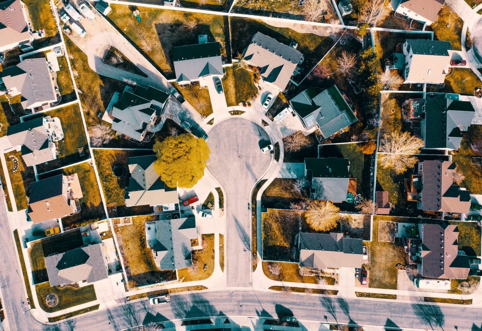 Aerial view of a suburban cul-de-sac ringed by single-family homes.